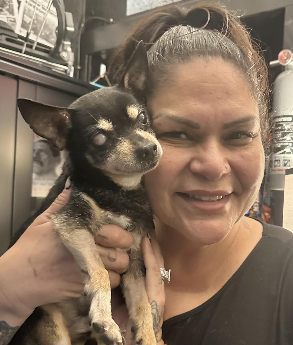 Foster Holding Blind Senior Rescue Dog Foster holding a small blind senior rescue dog with cloudy eyes